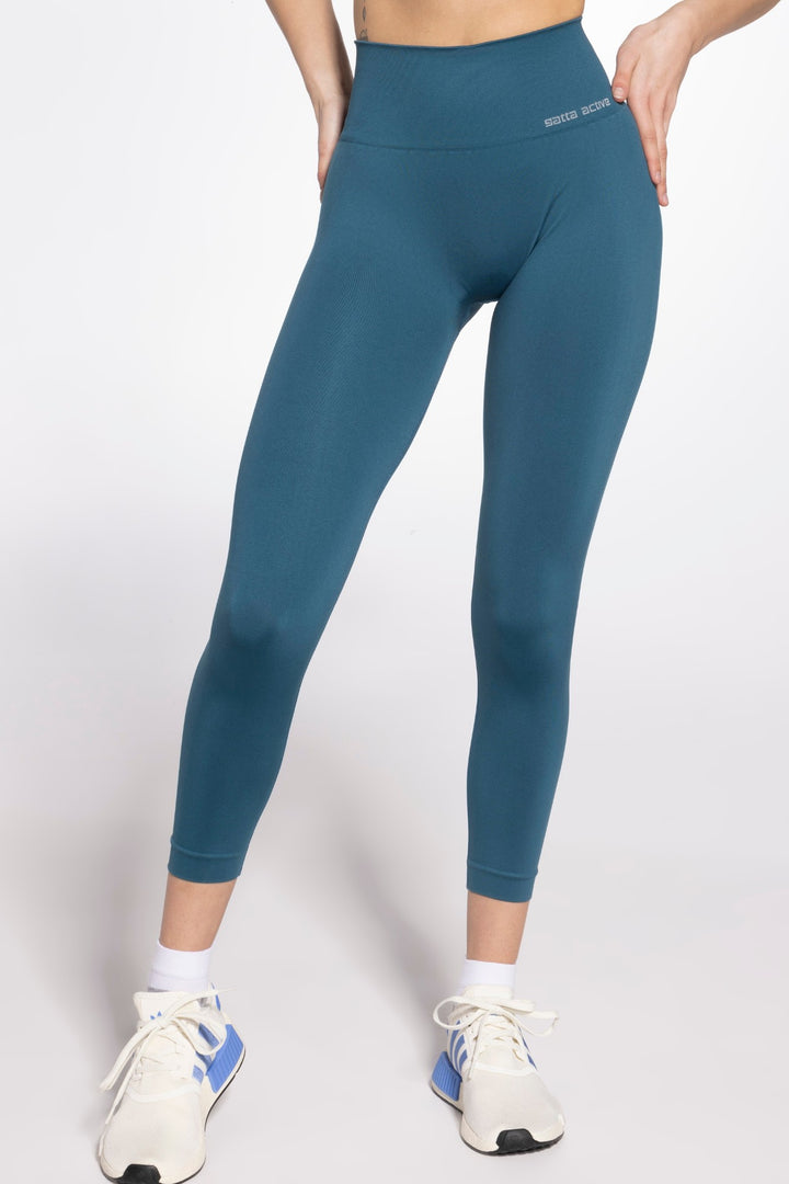 Model in green seamless sport leggings with contouring ribbed texture and compression fit, perfect for training or yoga