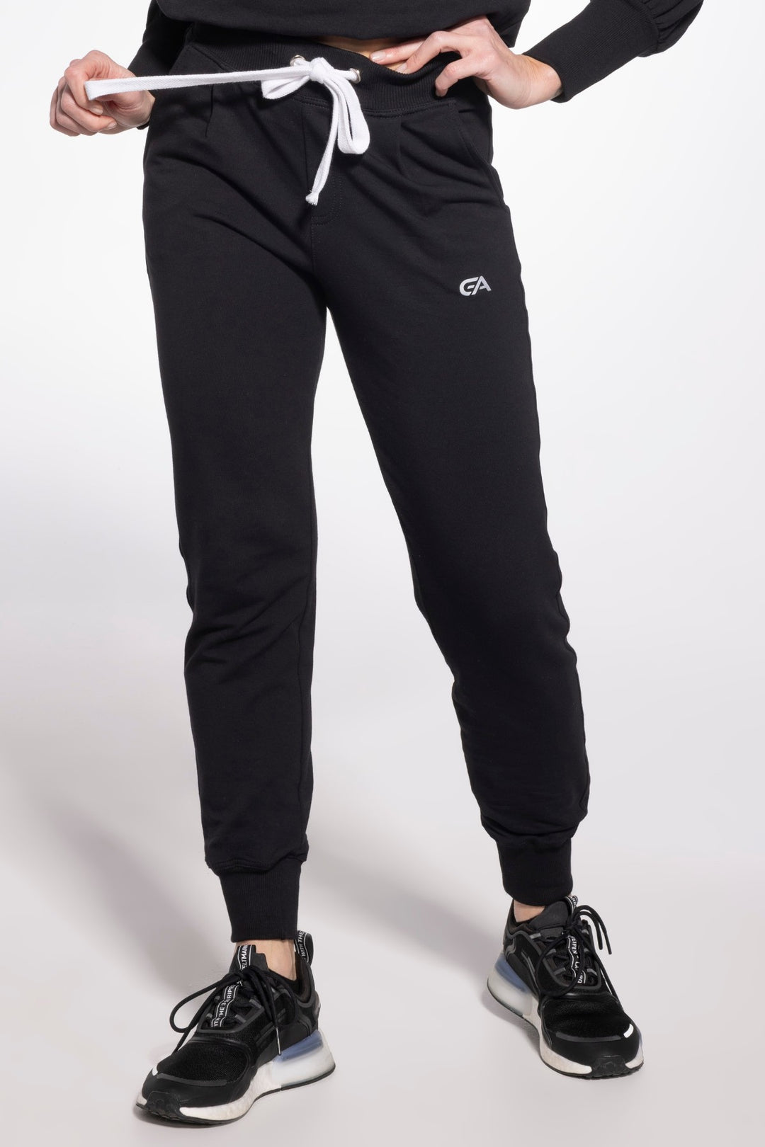 Black sport sweatpants featuring wide elastic bands at the ankles and reinforced stitching, combining durability with a sleek athletic style