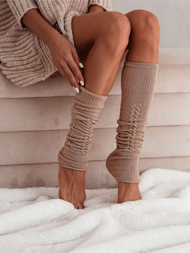 Women’s beige cotton openwork leg warmers. Lightweight, breathable leg warmers designed for warmth and fashionable layering