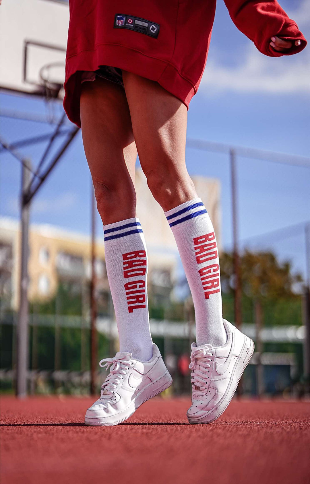 Women’s white and red cotton knee socks with Bad Girl pattern. Durable, comfortable socks ideal for bold, casual outfits