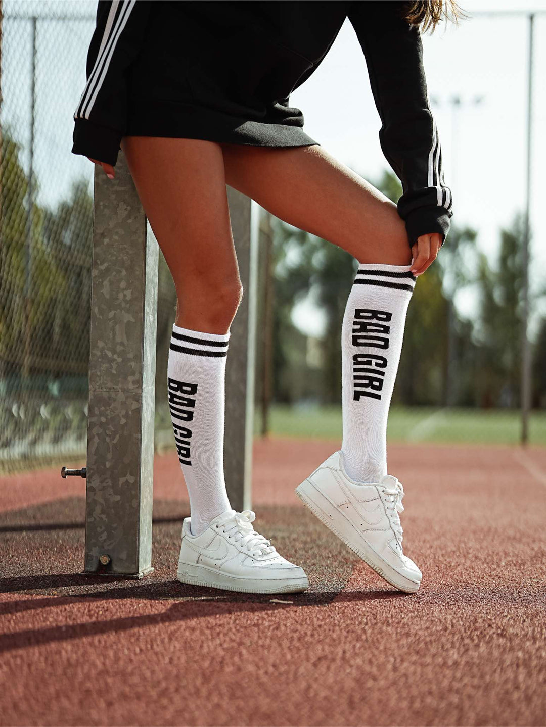 Women’s white and black cotton knee socks with Bad Girl pattern. Comfortable, breathable socks perfect for edgy, casual styling