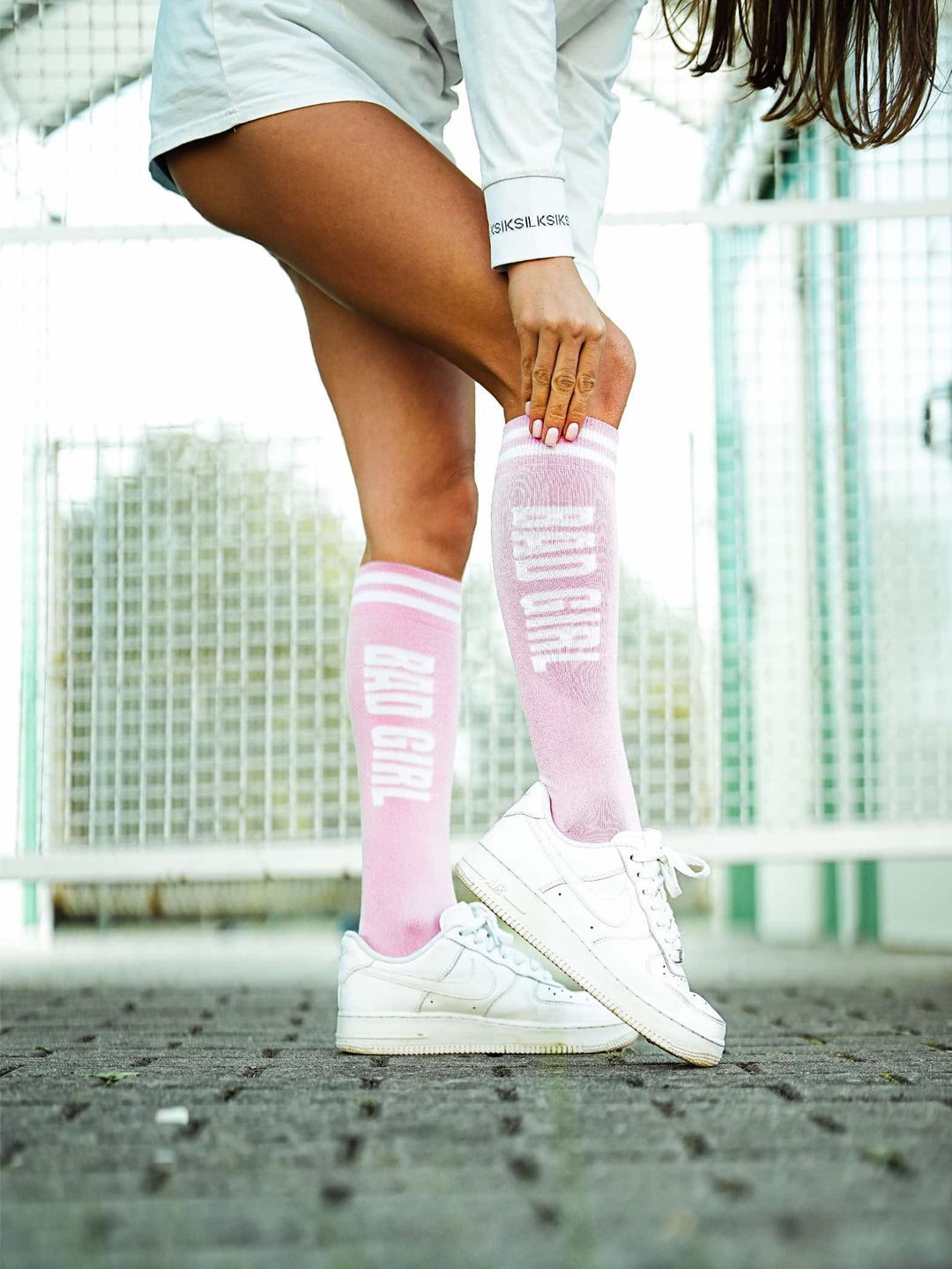 Women’s powder pink cotton knee socks featuring Bad Girl pattern. Soft, stylish socks designed for comfortable everyday wear