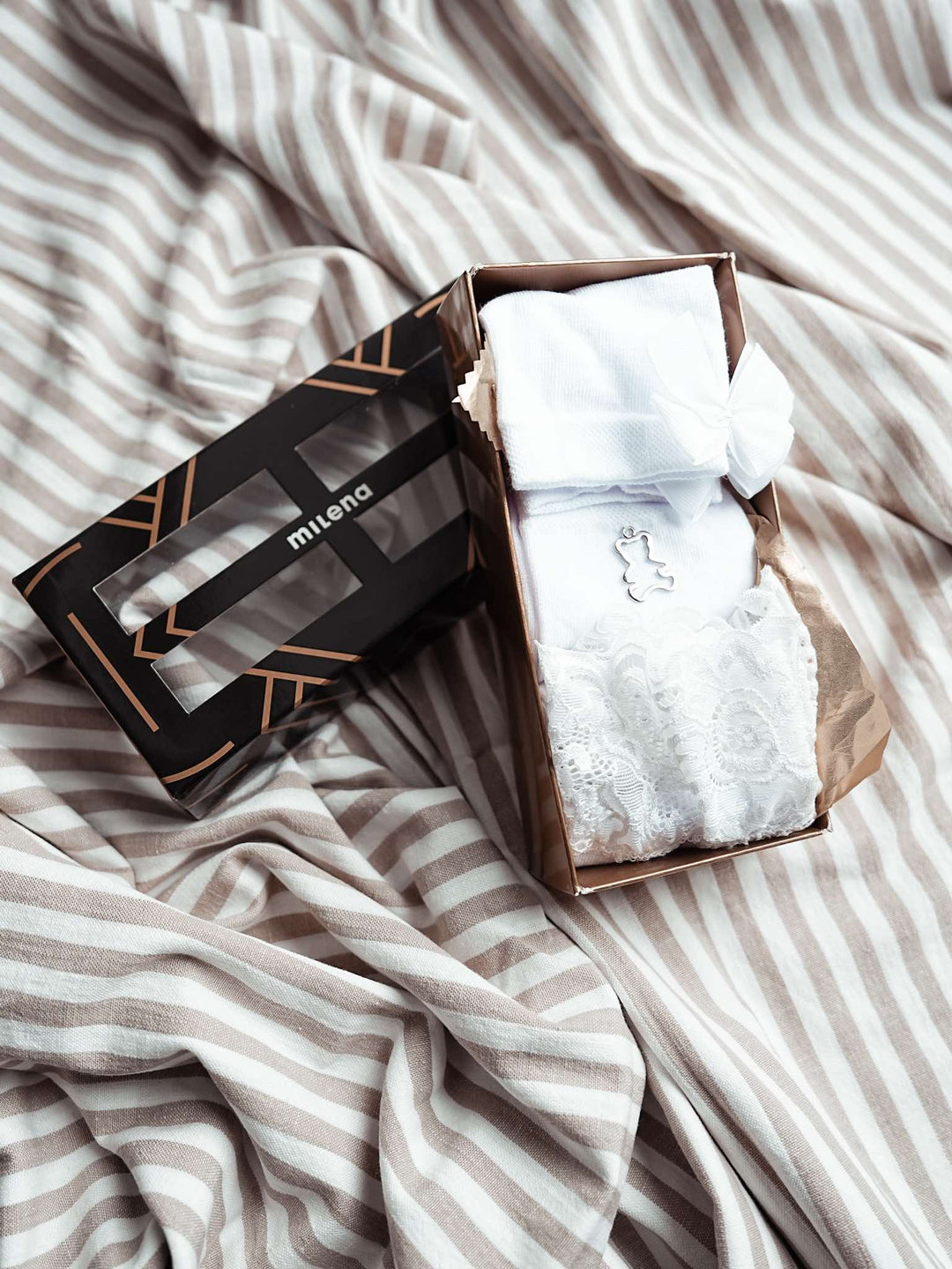 White women’s sock gift box with cotton ankle socks featuring metal emblem, ribbon, and lace details. Stylish and comfortable