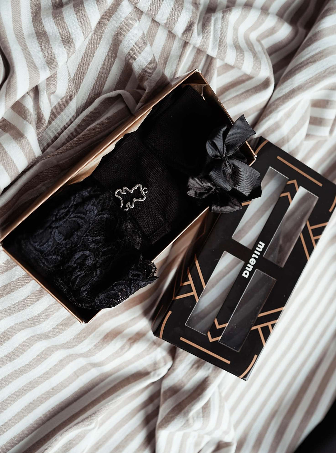 Black women’s sock gift box with soft cotton ankle socks including metal emblem, ribbon, and lace embellishments. Elegant and comfy