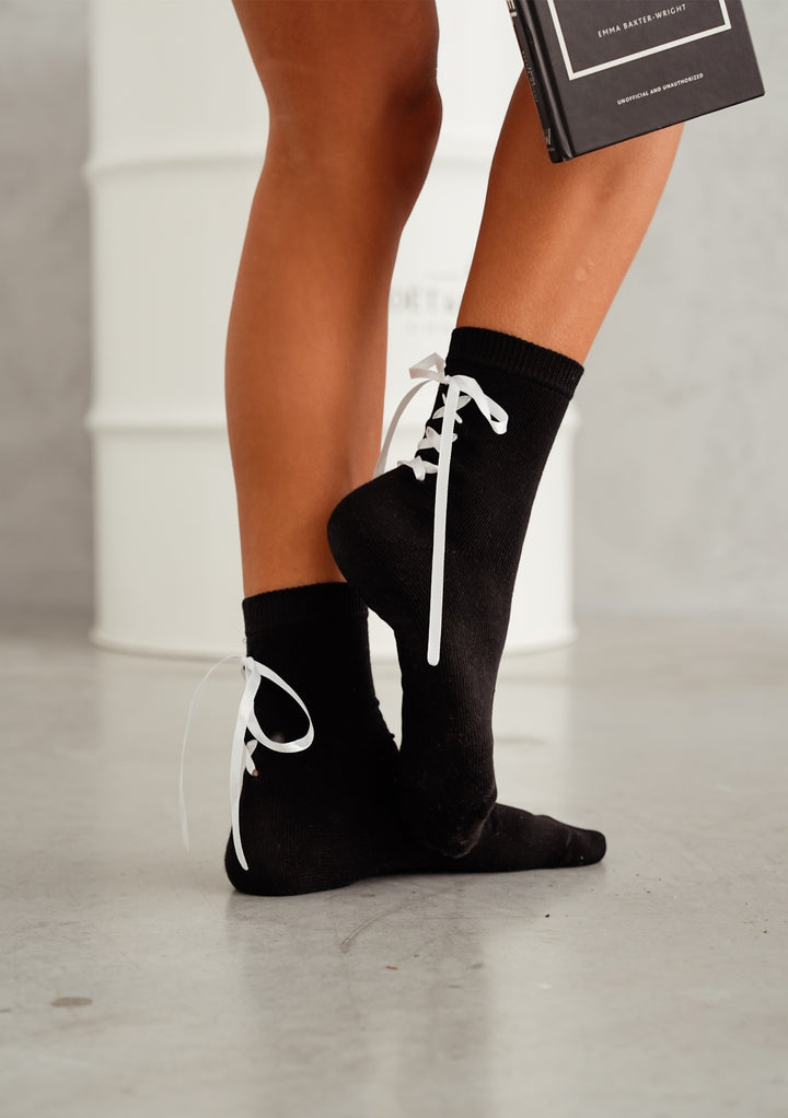Black laced ankle socks with ribbon on heel, soft cotton design for chic, comfortable, and stylish daily outfits