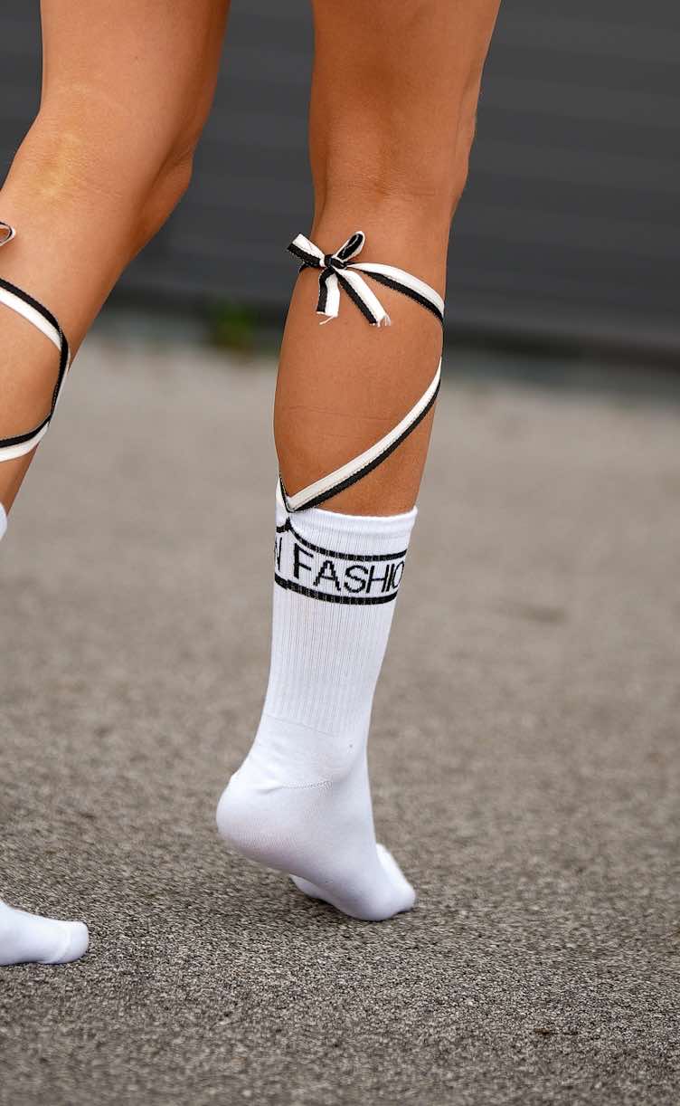 Close-up of ecru-colored cotton socks featuring stylish back tie and premium craftsmanship