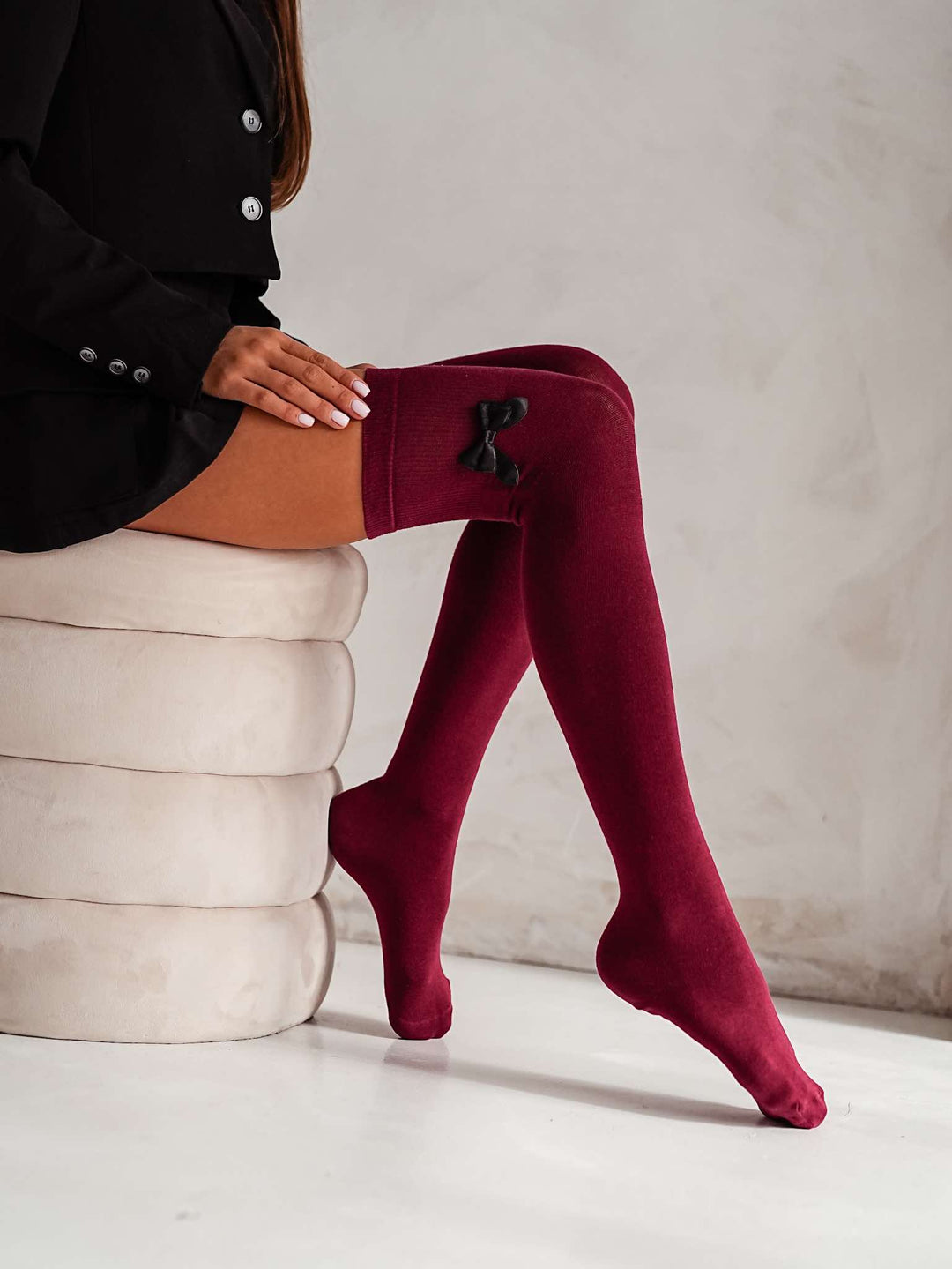 Rich claret cotton over knee socks featuring elegant bow, adding a bold and feminine flair to outfits