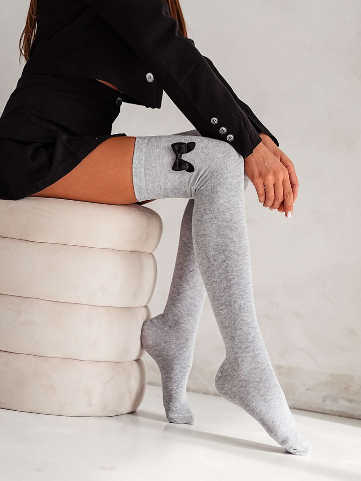 Soft light melange cotton over knee socks with charming bow, perfect for cozy and trendy layering
