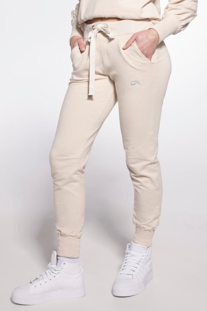 Vanilla sport sweatpants with wide elastic bands at the ankles, featuring a relaxed fit and breathable fabric for comfortable activewear