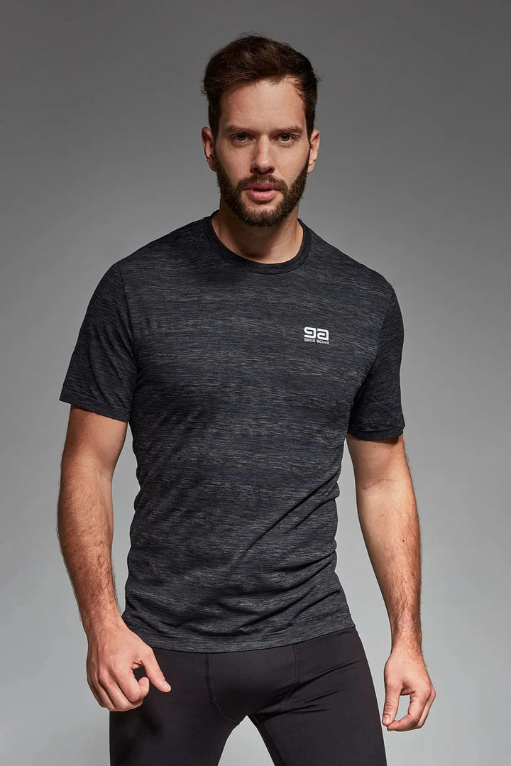 Model wearing graphite active T-shirt with ergonomic seams and stretch performance fabric, ideal for gym workouts and active lifestyles